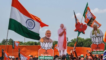 (File) BJP supporters raise slogans and display cut-outs. Reuters