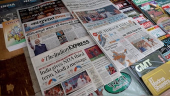 Newspapers are displayed at a roadside stall following the results of India's general election, in Ahmedabad, 5 June, 2024. Reuters