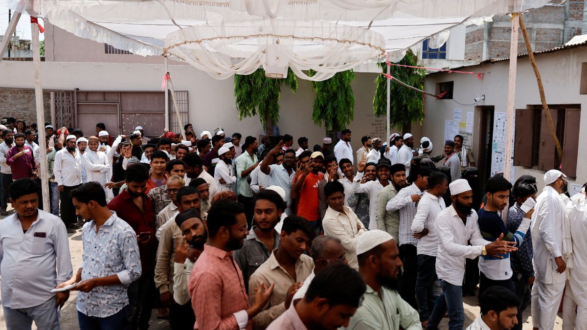 People stand outside a polling station during the fourth phase of India’s general election, in Beed, Maharashtra, 13 May, 2024. Reuters